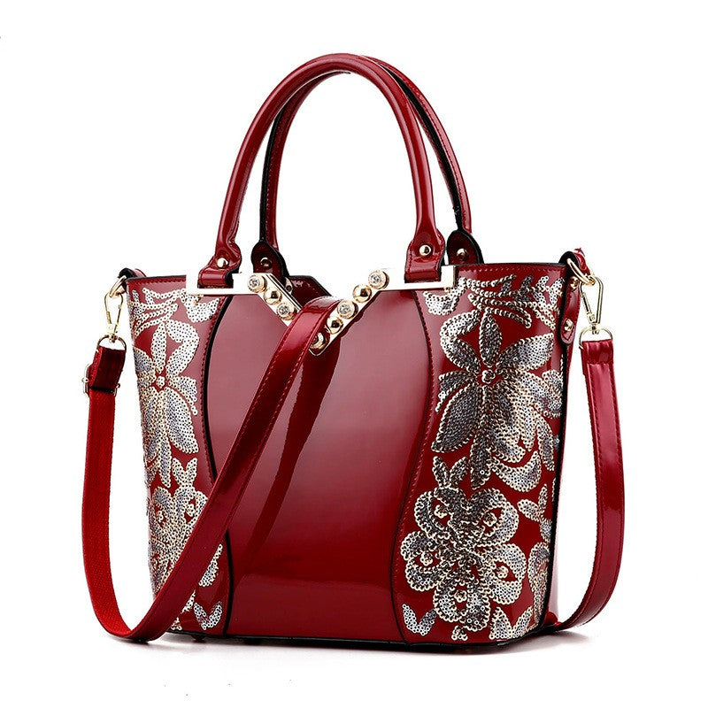 Embroidered bright leather shoulder bag